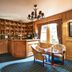 Loch Kinord Hotel in Aboyne bar area with wood paneling, stocked shelves, and seating by bright windows