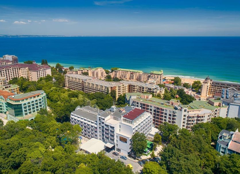 Prestige Deluxe Hotel Aquapark Club in Golden Sands with sea views over beachfront resort buildings.