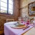 Glamping Canonici di San Marco in Mirano breakfast table in rustic stone room with window light