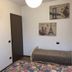 Casa Perlar in Verona room with twin beds, wall art, TV and a closed door