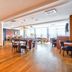 Kyriad Creteil - Bonneuil sur Marne breakfast room with tables, chairs and large windows in Bonneuil Sur Marne