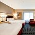 TownePlace Suites by Marriott Dallas Lewisville guest room with two beds, TV, and red chair