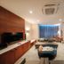 Petro Hotel in Vung Tau lounge with sofa, TV, coffee table and window seating