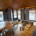 Chalet Hotel Régina in Les Gets lounge with wood-paneled ceiling, sofa, tables and large windows