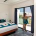 Casa Ticul Hotel By Bfh in Playa del Carmen room with balcony view and woman standing by window