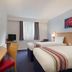 Ramada by Wyndham Wakefield in Ossett hotel room with two twin beds, desk, TV and window