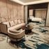 Zhongyuan Hotel in Anyang guest suite with sitting area, sofa, chairs and patterned carpet