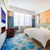 Hulunbeier Hotel in Hulunbuir guest room with twin beds, colorful carpet, and large window