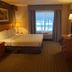 Wingate by Wyndham Coon Rapids guest room with queen bed, desk, TV and window view