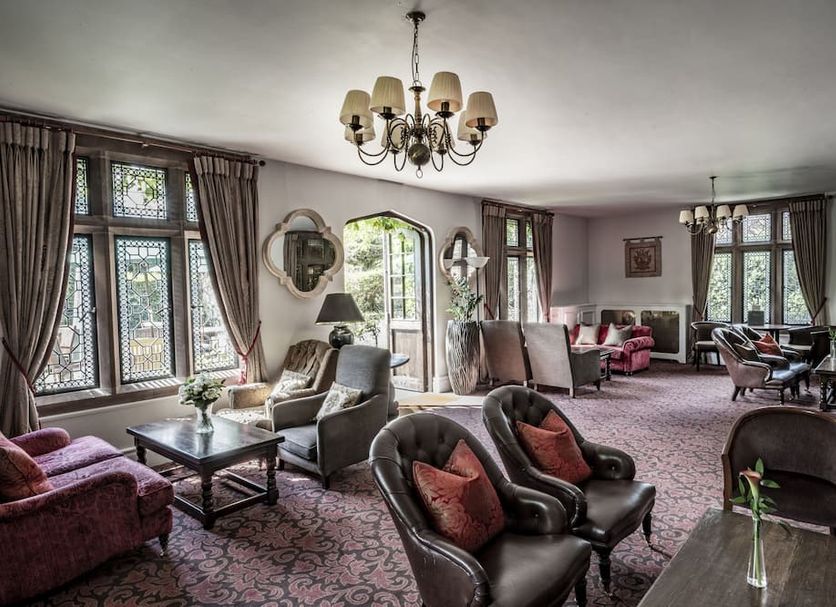 New Hall Hotel & Spa in Sutton Coldfield lounge with chandeliers, patterned carpet, and large windows