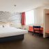 B&B HOTEL Katowice Centrum guest room with double bed, desk, and city-view window in Katowice