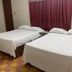 Hotel Papagayo Veracruz guest room with two double beds and red curtains