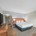 Hampton Inn & Suites Ft. Lauderdale West-Sawgrass/Tamarac Tamarac guest room with king bed and wall-mounted TV