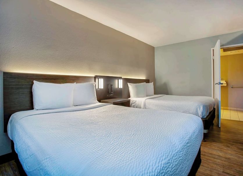 Motel 6-Kingman, Az - Route 66 East room with two beds and open bathroom door in Kingman
