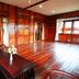 Jambuluwuk Convention Hall & Resort Puncak in Tapos wood-paneled room with large windows and polished floors