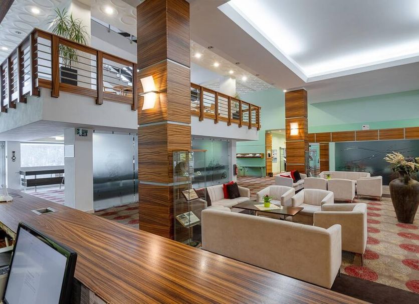 Hotel Behounek in Jáchymov lobby with seating area, mezzanine balcony, and wood-accented interior