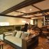 Sumiya Kiho-An Ryokan lounge in Kameoka with sofa, chairs, tables and book-filled shelves