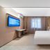 Hanting Hotel Shenyang Santaizi Metro Station guest room with bed, TV, desk and window in Shenyang