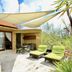 O Villas Seminyak in Kuta: private villa terrace with lounge chairs, outdoor dining, and shaded canopy