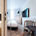The Originals Boutique, Hôtel Maison Montmartre Paris Les Puces room with bathroom vanity, bed and balcony chair in Paris