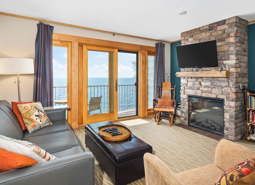 East Bay Suites in Grand Marais living room with fireplace, TV, balcony and lake view