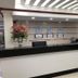 Tri Hotel Centro Chapecó lobby reception desk with floral arrangements and wall clocks in Chapecó