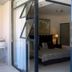 1109 The Decks at 67 Long Street, Cape Town: balcony doorway to a bedroom with a lit lamp and bed