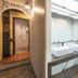 Suneta Hostel Khaosan in Bangkok, shared bathroom with double sinks and arched doorway