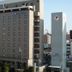 Sky Hotel in Matsuyama, exterior view of a multi-story hotel building in an urban area
