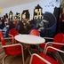 Medicine Hat Suites lounge with red and blue chairs, white tables, and Batman mural in Medicine Hat