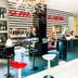 Hotel Le Cinéma in Gatteo lobby bar and reception with black-and-white striped walls and chandeliers
