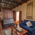 Yangshuo Secret Garden in Guilin with a rustic lounge, blue sofa, wooden table, and sliding wooden doors.