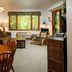 The Inn at Little Sister Hill in Sister Bay living room with dining table, sofa, window view and deck chair