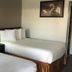Travelodge by Wyndham Sacramento / Rancho Cordova room with two double beds and lamp
