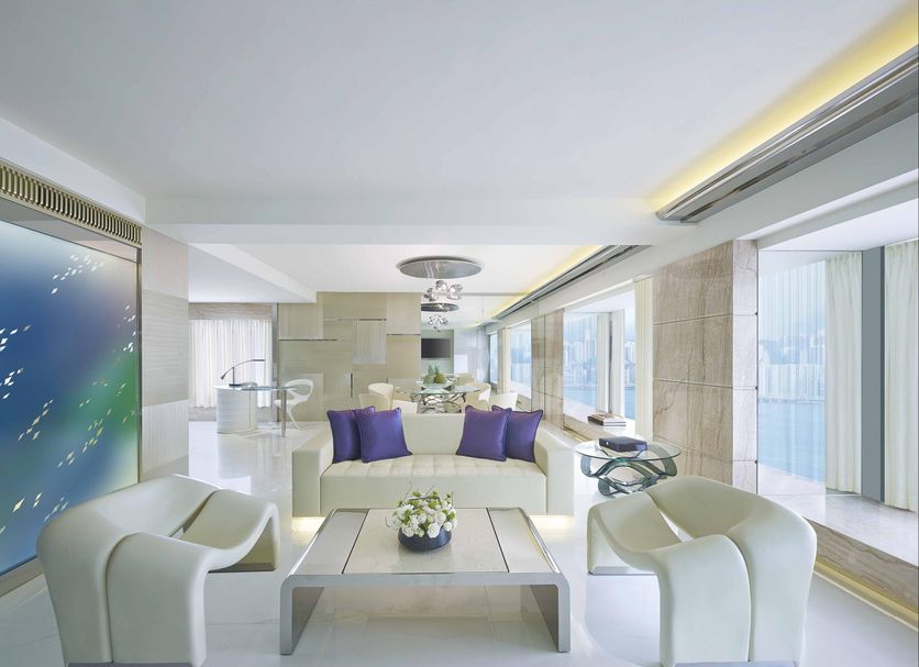 Regal Kowloon Hotel in Hong Kong living area with white seating and city-view windows