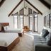 Hôtel Lac Carling Golf & Spa in Grenville guest room with two beds, vaulted wood beams and large windows