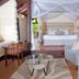 Great Rift Valley Lodge and Golf Resort in Naivasha guest suite with canopy bed and seating area