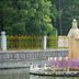 Sea Shore Garden Hotel Qingdao statue on lotus platform by pond, surrounded by trees in Qingdao