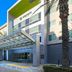 Element Ontario Rancho Cucamonga hotel entrance in Ontario with palm trees and glass canopy
