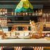 ibis budget Valencia Aeropuerto breakfast buffet with bread baskets, jam jars and colorful hanging lamps