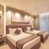 Grand Residency Hotel & Serviced Apartments in Mumbai: twin beds, floor-to-ceiling curtains, and a seating area