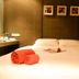 Justbeds Bangkok room with neatly made bed and rolled orange towels