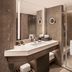 JW Marriott Hotel Hong Kong bathroom with double vanity, large mirror, walk-in shower and towel rack