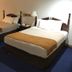 Denison Inn & Suites in Denison: guest room with two double beds, chairs, and bedside lamp