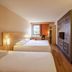 ibis Sarlat room with two beds, window view and wooden floor in Sarlat-la-Canéda