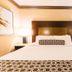 Crowne Plaza Harrisburg-Hershey guest room with king bed, bedside lamps, and patterned bedding