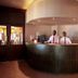 Omali São Tomé reception desk with two staff members in a hotel lobby