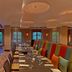 Sheraton Mallorca Arabella Golf Hotel in Palma de Mallorca dining room with striped banquette seating and set tables