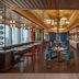 Hilton Saigon restaurant in Ho Chi Minh City with city views, blue chairs and gold ceiling accents