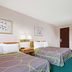 Super 8 by Wyndham Kenmore/Buffalo/Niagara Falls Area room with two beds, desk and chair in Kenmore
